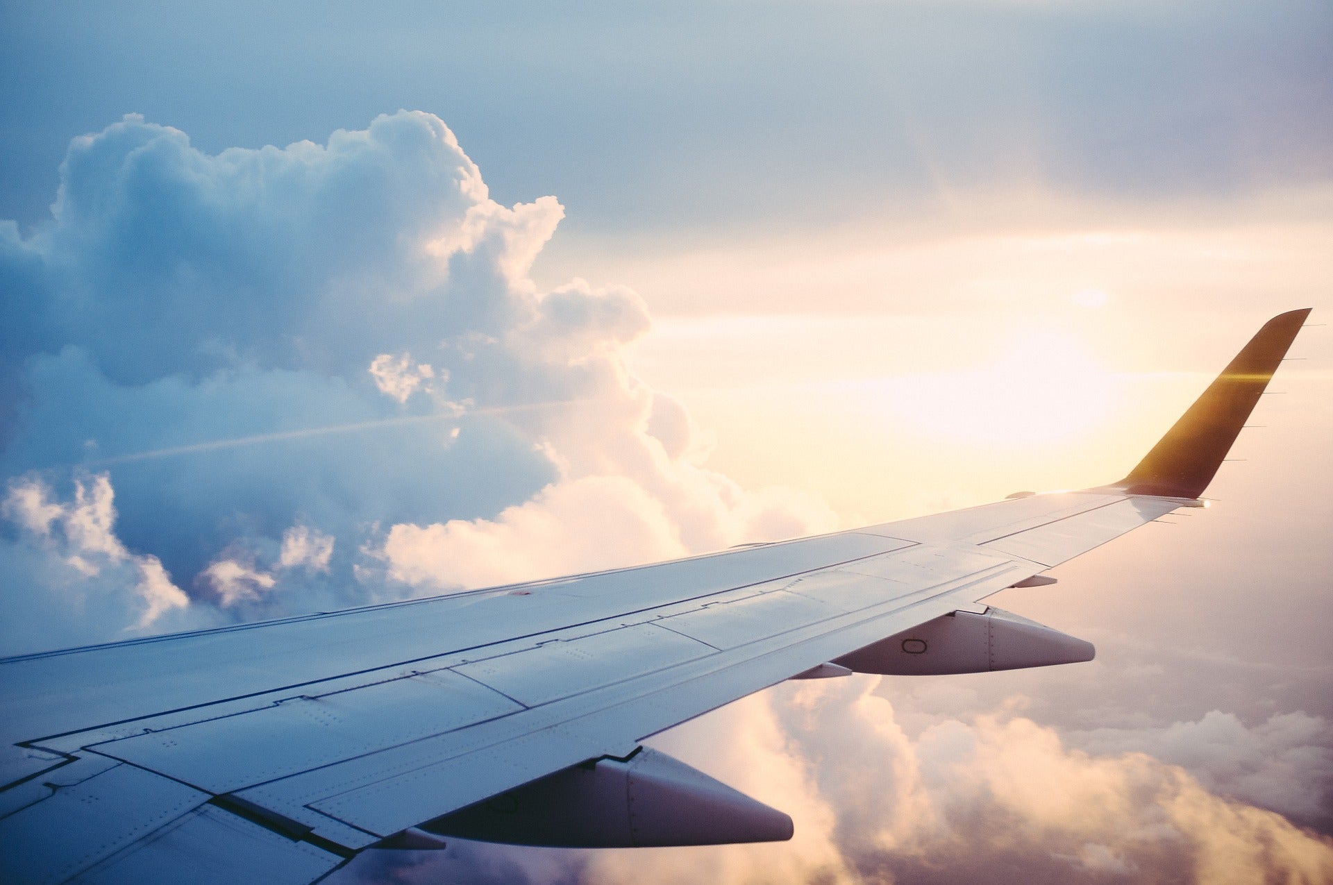 Plane wings in the clouds. Article by Pulvis Art Urns