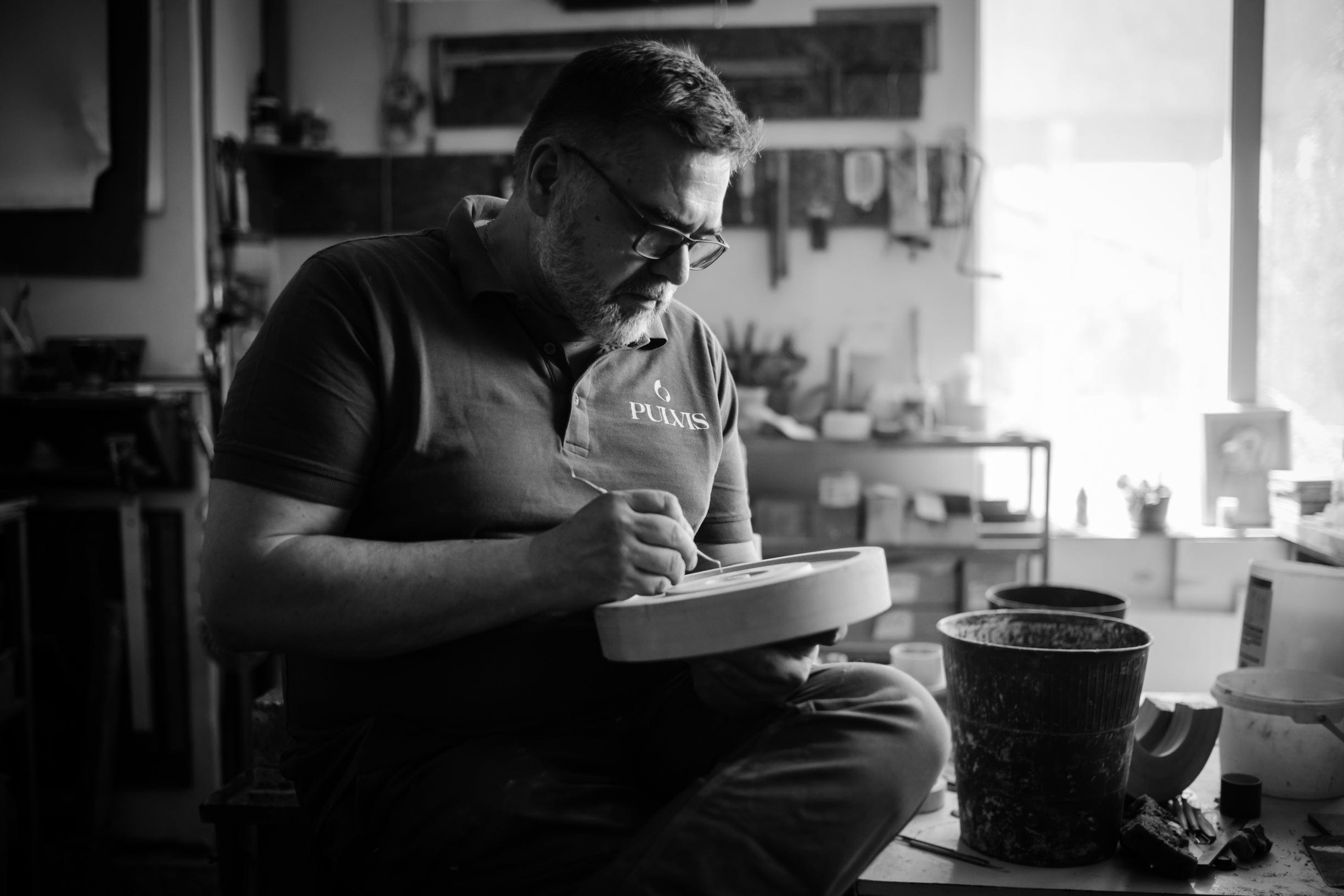 Person working on a craft project in a workshop - Mihail Mihaylov Pulvis Art urns